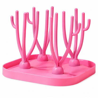 egouttoir biberon rose sur la table.